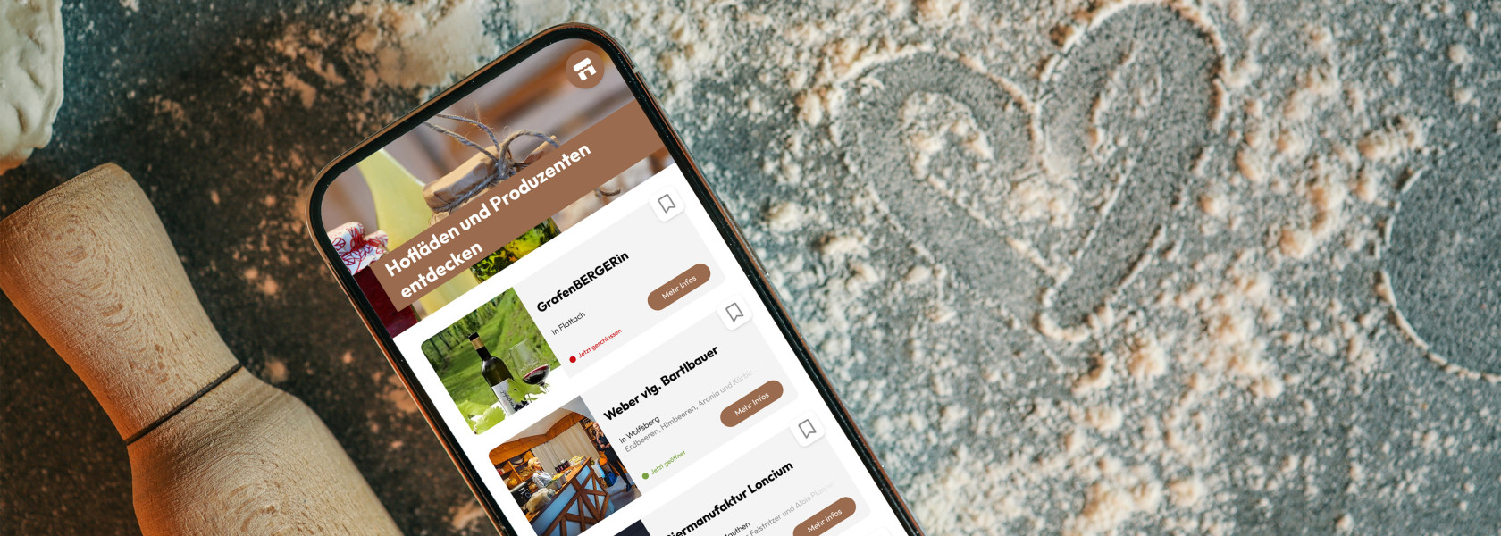 Smartphone liegt auf Arbeitsfläche das auf dem Display einen Ausschnitt der Slow-Food-Guide Website zeigt